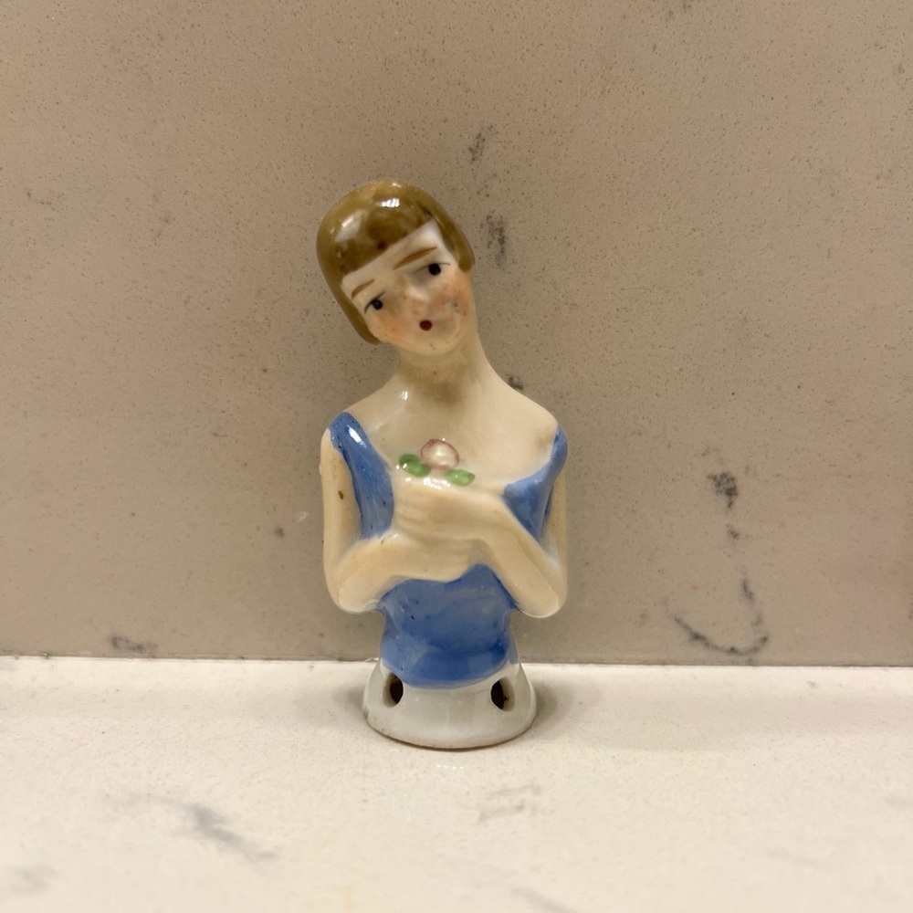 Antique German glazed porcelain Half Doll. Blonde hair, blue top. Holding flower